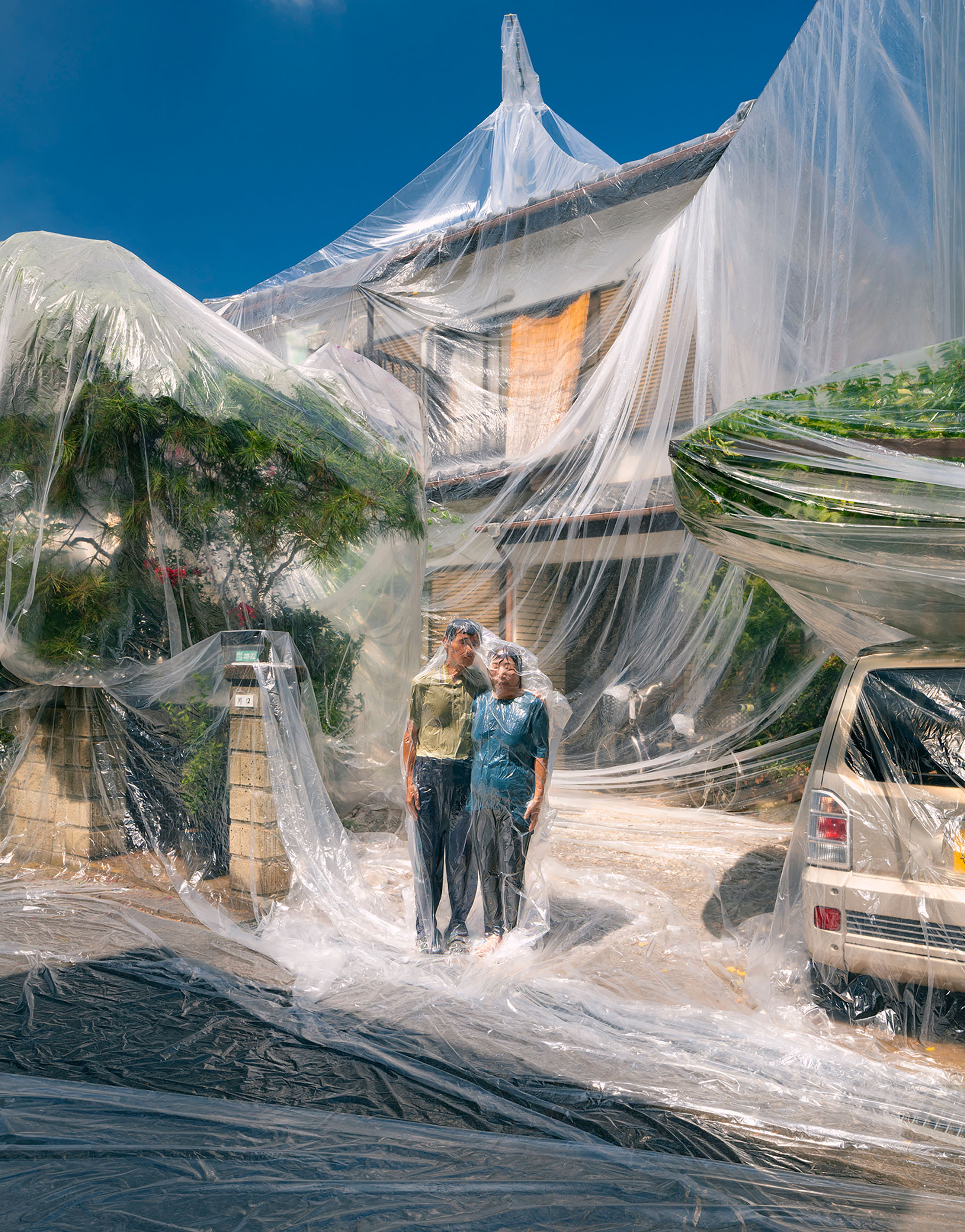 Photographer Hall shrink wraps couple and house in family photo